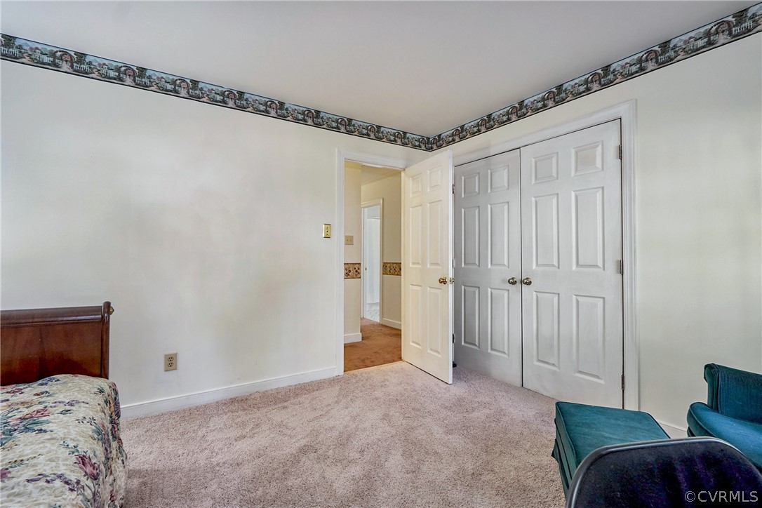 13816 Laurel Spring Road Chester, VA 23831 - Photo 20 of 31 a bedroom with a bed and a mirror