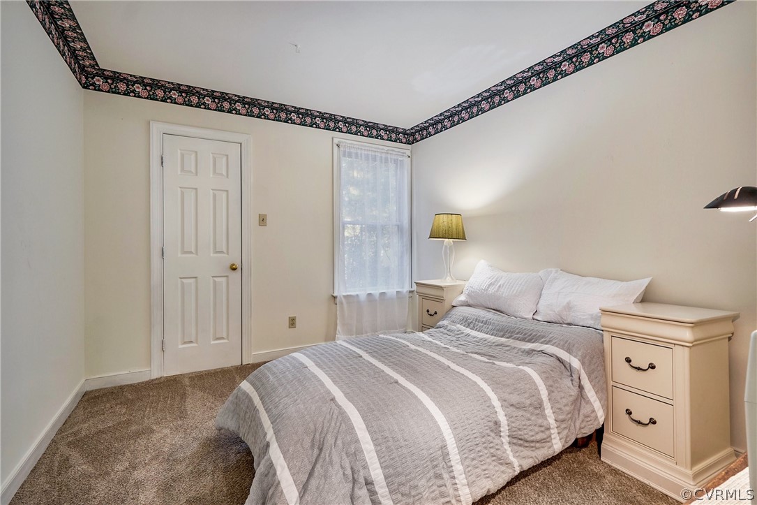 13816 Laurel Spring Road Chester, VA 23831 - Photo 22 of 31 a bedroom with a bed and a window