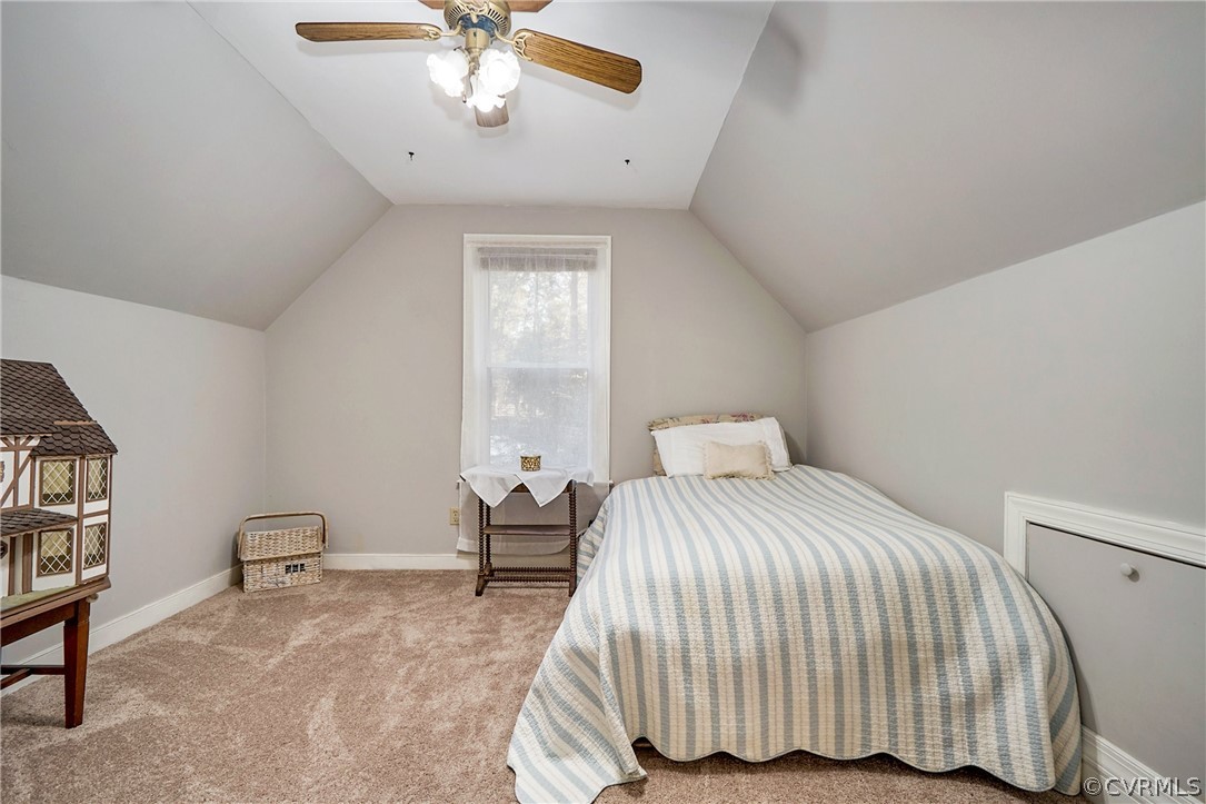 13816 Laurel Spring Road Chester, VA 23831 - Photo 24 of 31 a bedroom with a bed and a chandelier