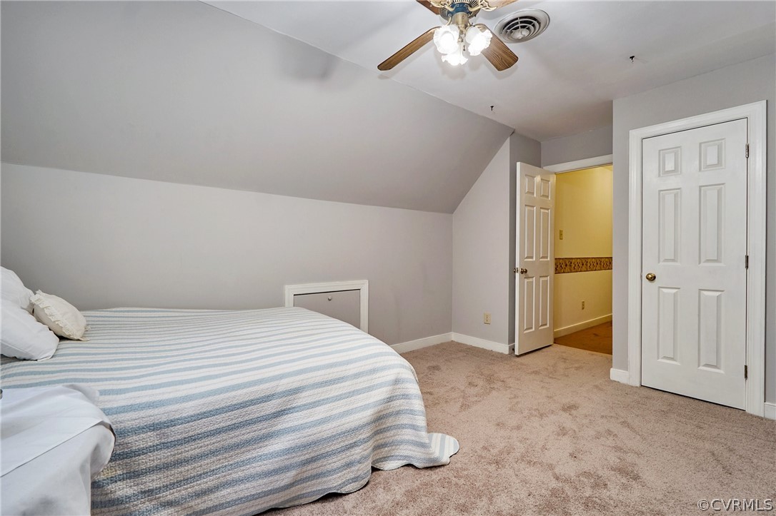 13816 Laurel Spring Road Chester, VA 23831 - Photo 25 of 31 a bedroom with a bed and a chandelier