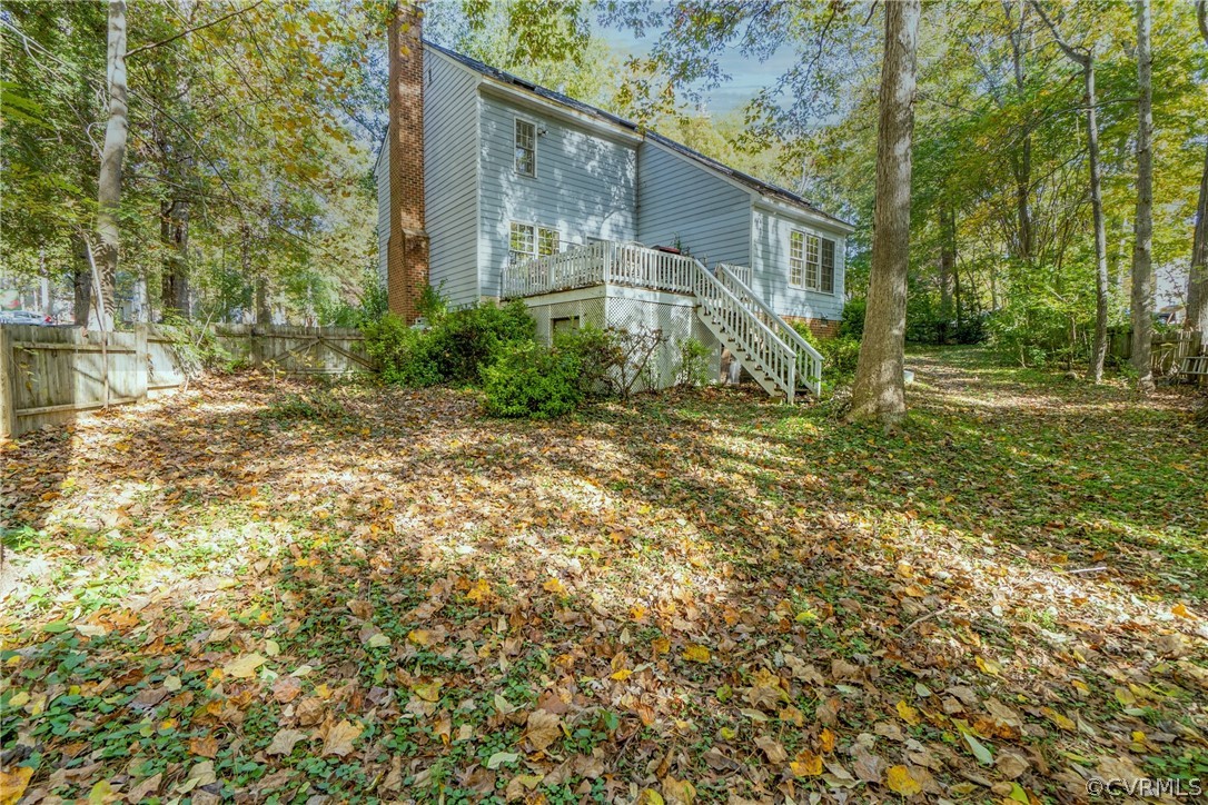 13816 Laurel Spring Road Chester, VA 23831 - Photo 27 of 31 a backyard of a house with plants and large trees