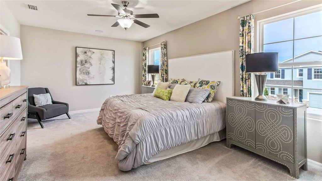 17886 Acorn Drop Road Land O Lakes, FL 34638 - Photo 11 of 17 a bedroom with a bed and chair