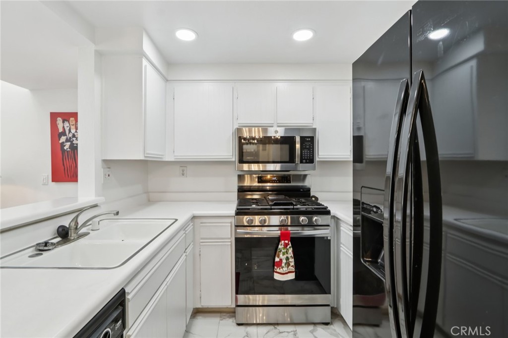 23605 Del Monte Dr., Unit 252 Valencia, CA 91355 - Photo 10 of 48 a kitchen that has a sink and a stove top oven