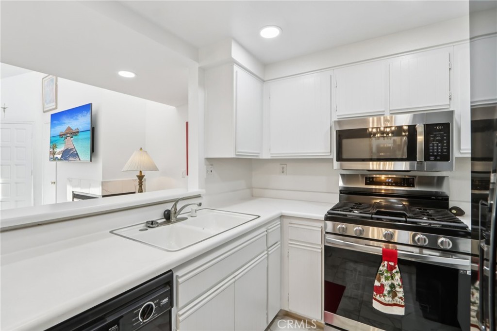 23605 Del Monte Dr., Unit 252 Valencia, CA 91355 - Photo 11 of 48 a kitchen with a sink appliances and cabinets