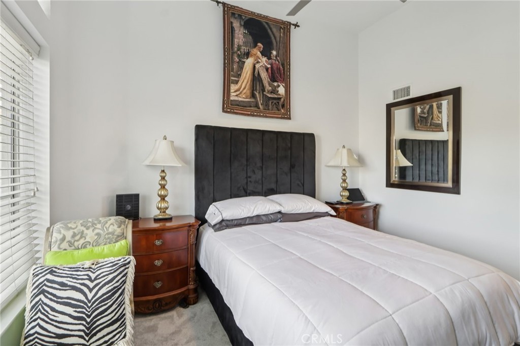 23605 Del Monte Dr., Unit 252 Valencia, CA 91355 - Photo 22 of 48 a bedroom with a bed and a lamp on dresser