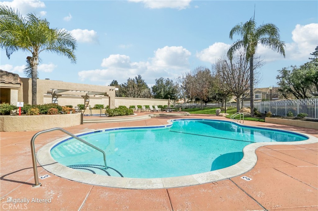 23605 Del Monte Dr., Unit 252 Valencia, CA 91355 - Photo 28 of 48 a view of a swimming pool and trees in th background