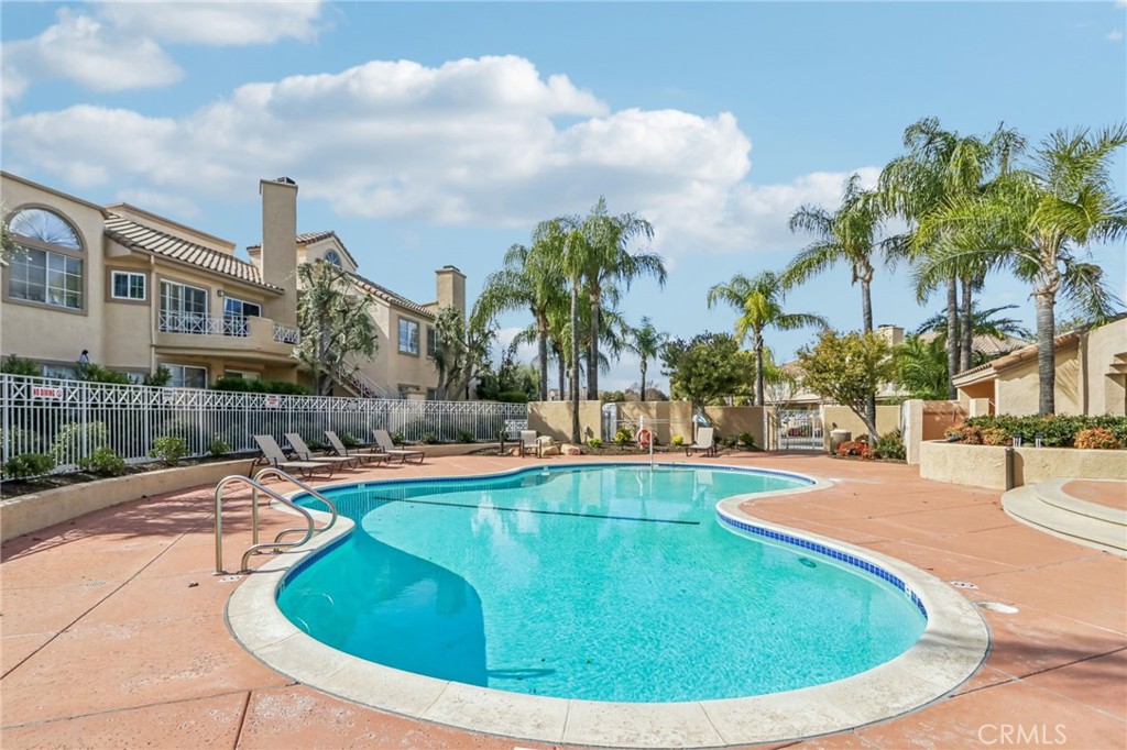 23605 Del Monte Dr., Unit 252 Valencia, CA 91355 - Photo 32 of 48 a view of a swimming pool with a lounge chairs