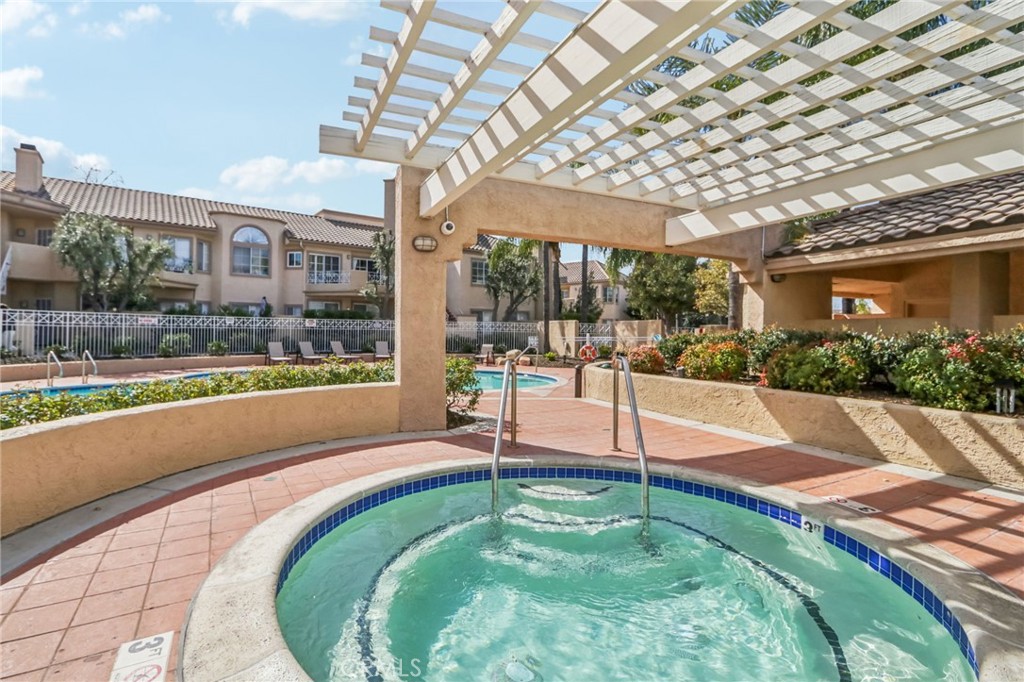 23605 Del Monte Dr., Unit 252 Valencia, CA 91355 - Photo 36 of 48 a swimming pool with outdoor seating and yard
