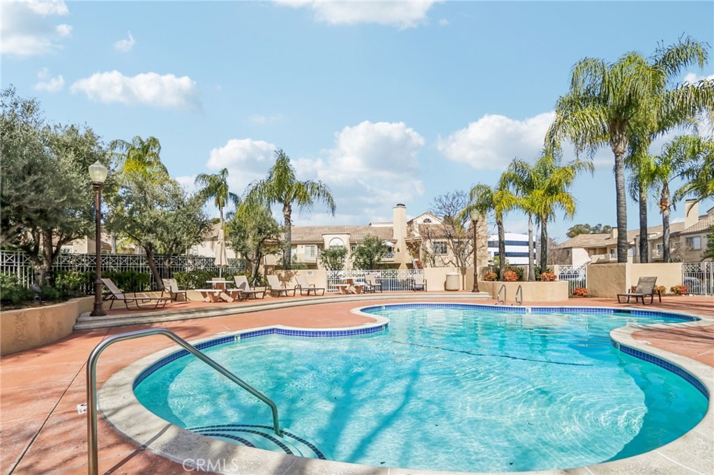 23605 Del Monte Dr., Unit 252 Valencia, CA 91355 - Photo 43 of 48 a view of a swimming pool with a fountain and plants