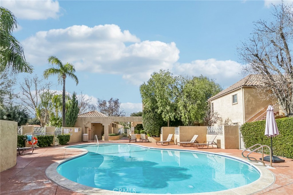 23605 Del Monte Dr., Unit 252 Valencia, CA 91355 - Photo 44 of 48 a view of a house with swimming pool and sitting area