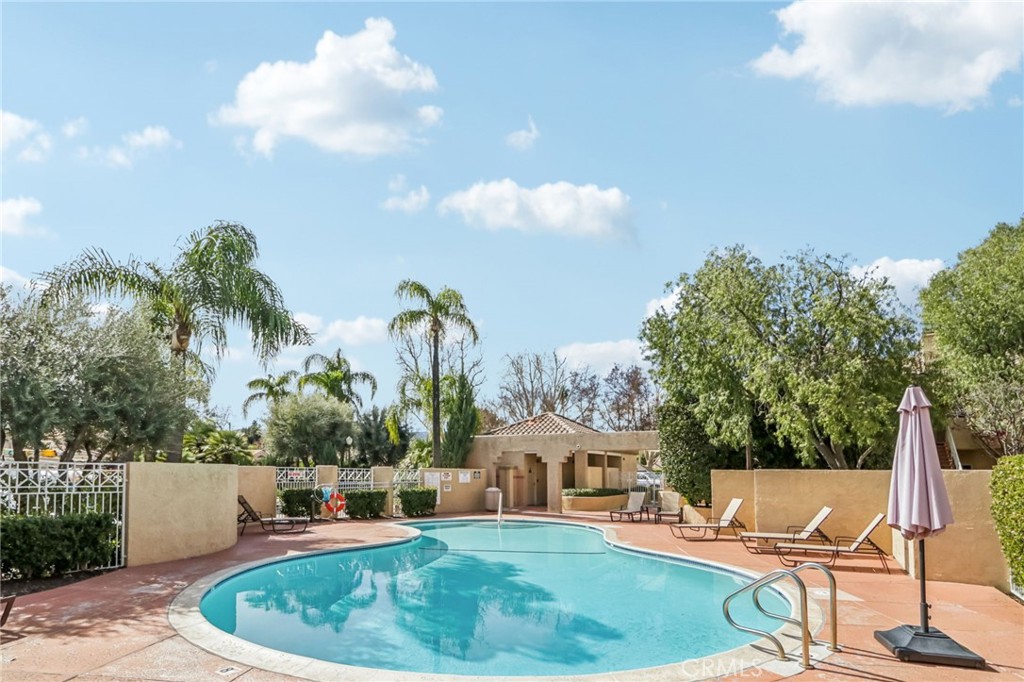 23605 Del Monte Dr., Unit 252 Valencia, CA 91355 - Photo 45 of 48 a view of a swimming pool with a lounge chairs