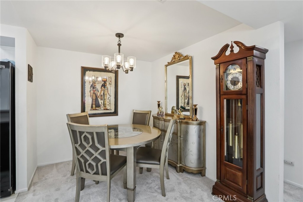 23605 Del Monte Dr., Unit 252 Valencia, CA 91355 - Photo 8 of 48 a view of a dining room with furniture and chandelier