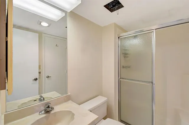 a bathroom with a shower and a sink