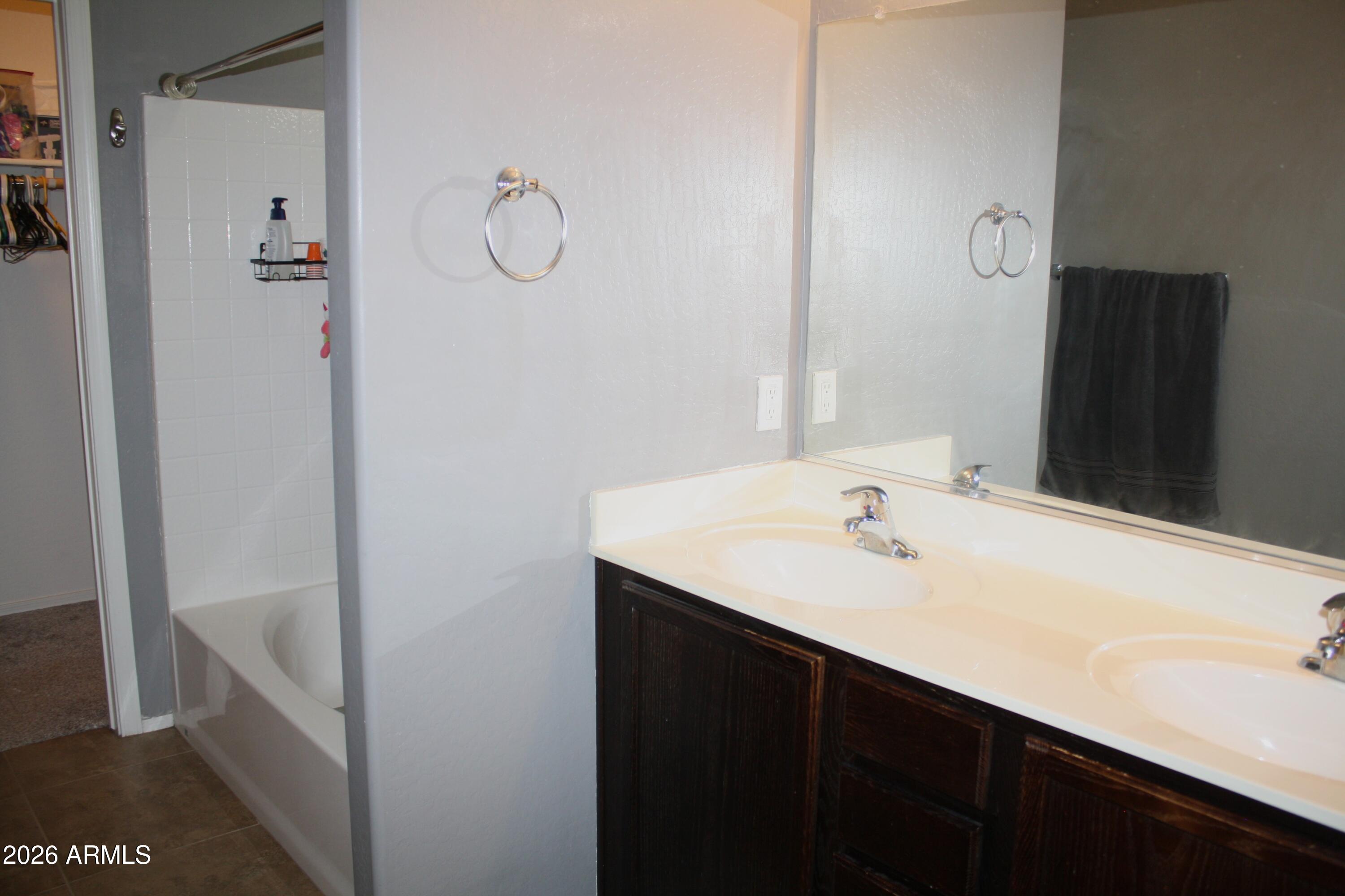 10225 West Camelback Road, Unit 19 Phoenix, AZ 85037 - Photo 35 of 51 a bathroom with a sink and a mirror