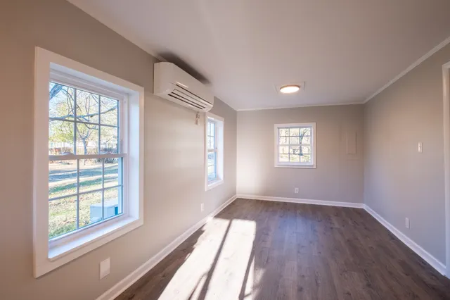 a view of an empty room with wooden floor