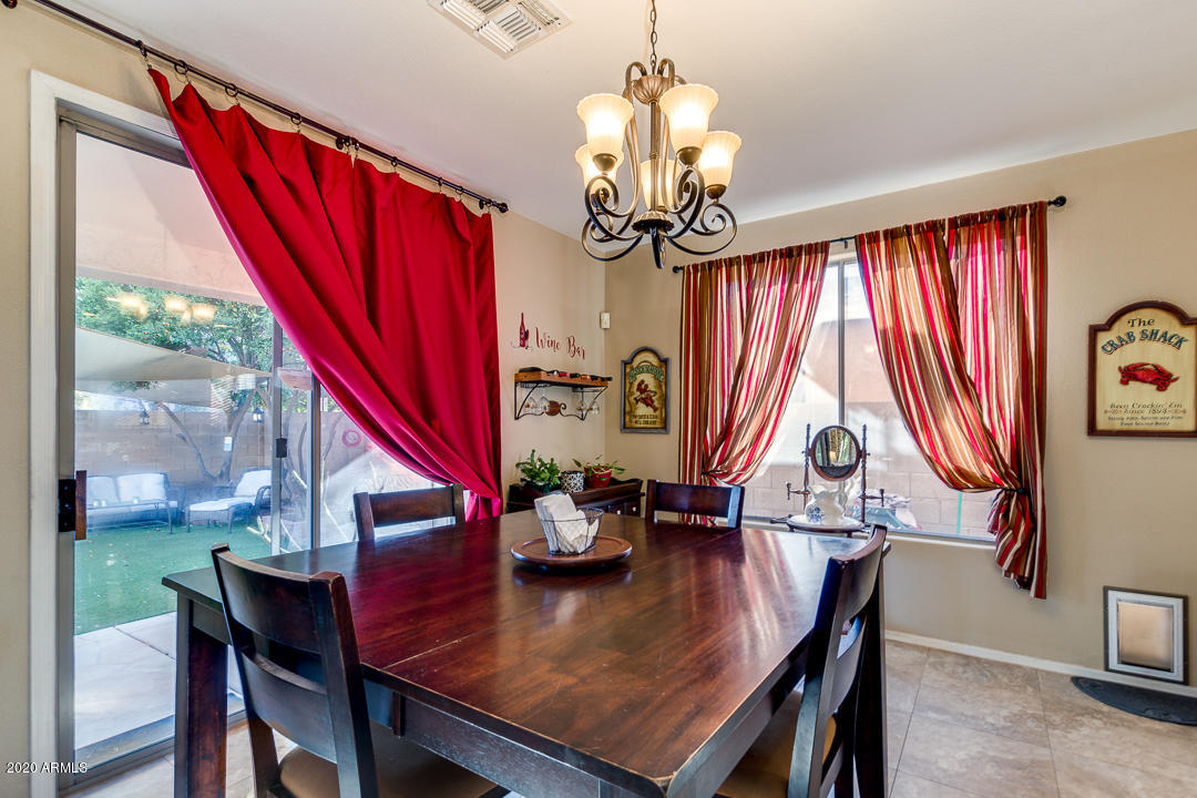 1163 East Ranch Court Gilbert, AZ 85296 - Photo 12 of 36 a view of a dining room with furniture window and wooden floor