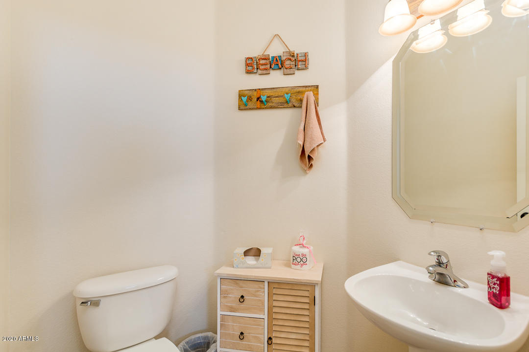 1163 East Ranch Court Gilbert, AZ 85296 - Photo 13 of 36 a bathroom with a sink a toilet and a mirror