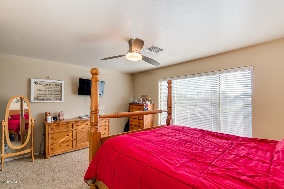 1163 East Ranch Court Gilbert, AZ 85296 - Photo 16 of 36 a bedroom with a large bed and a large window
