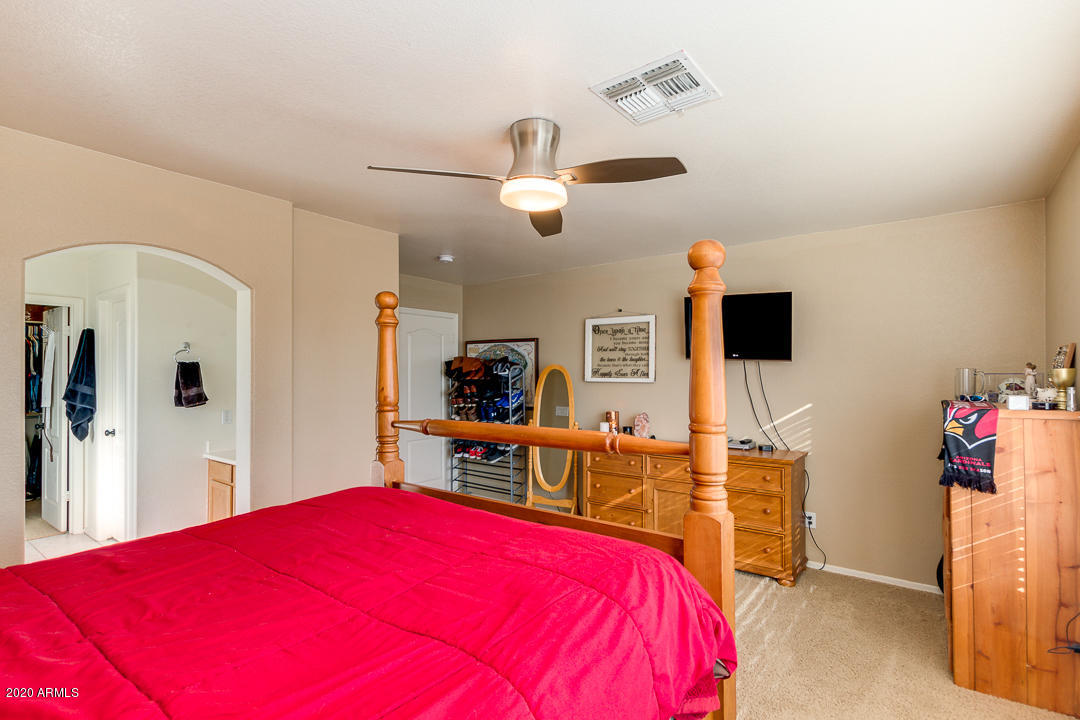 1163 East Ranch Court Gilbert, AZ 85296 - Photo 17 of 36 a bedroom with a bed and a flat screen tv