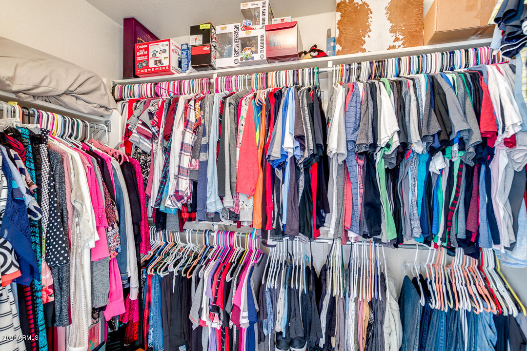 1163 East Ranch Court Gilbert, AZ 85296 - Photo 20 of 36 a view of walk in closet with clothes