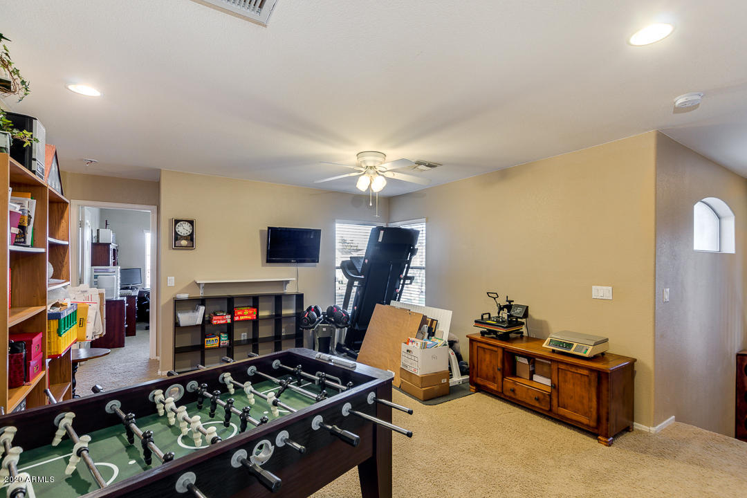 1163 East Ranch Court Gilbert, AZ 85296 - Photo 21 of 36 a living room with furniture and a flat screen tv
