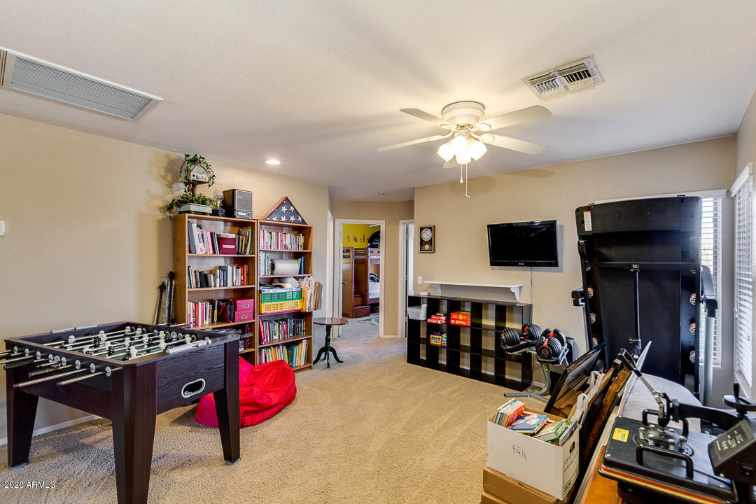 1163 East Ranch Court Gilbert, AZ 85296 - Photo 22 of 36 a view of a workspace with furniture and a flat screen tv