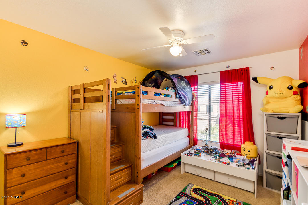 1163 East Ranch Court Gilbert, AZ 85296 - Photo 24 of 36 a bedroom with a bed and a chandelier
