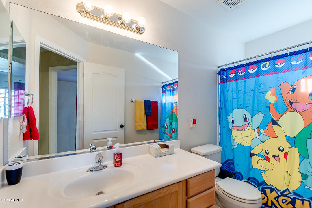 1163 East Ranch Court Gilbert, AZ 85296 - Photo 25 of 36 a bathroom with a sink vanity mirror and toilet
