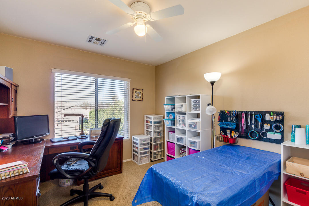 1163 East Ranch Court Gilbert, AZ 85296 - Photo 26 of 36 a view of a workspace with furniture and a bookshelf
