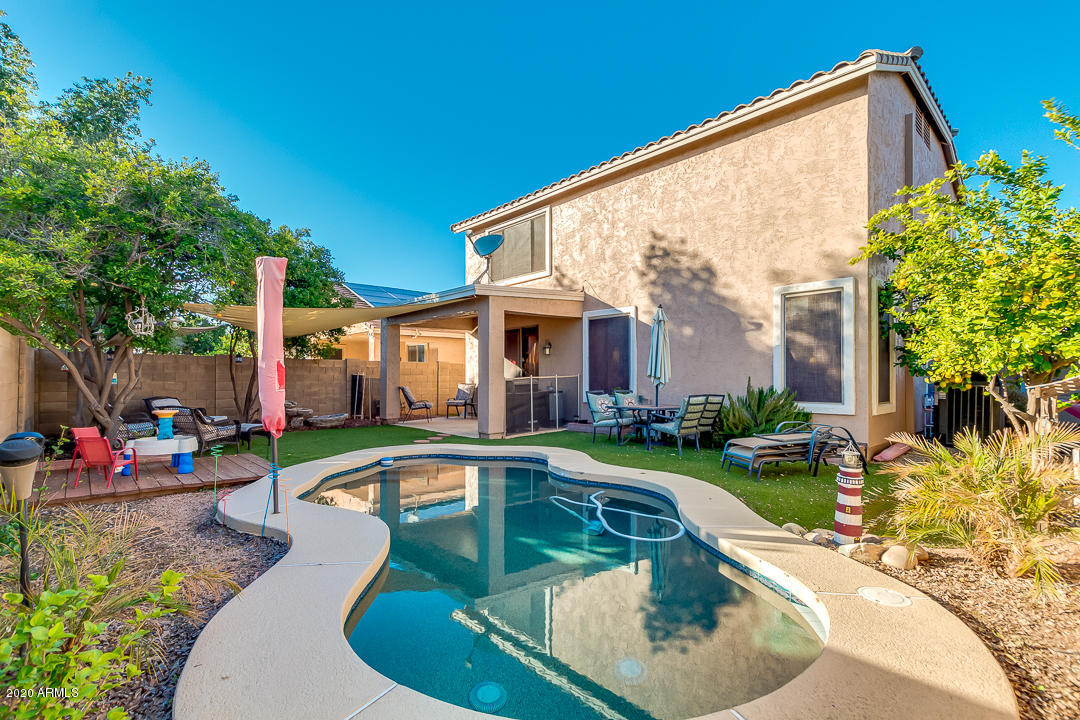 1163 East Ranch Court Gilbert, AZ 85296 - Photo 28 of 36 a view of a house with swimming pool and sitting area
