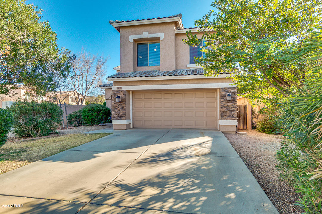 1163 East Ranch Court Gilbert, AZ 85296 - Photo 3 of 36 a front view of a house with a yard and garage