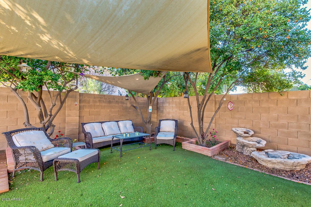 1163 East Ranch Court Gilbert, AZ 85296 - Photo 32 of 36 a backyard of a house with table and chairs