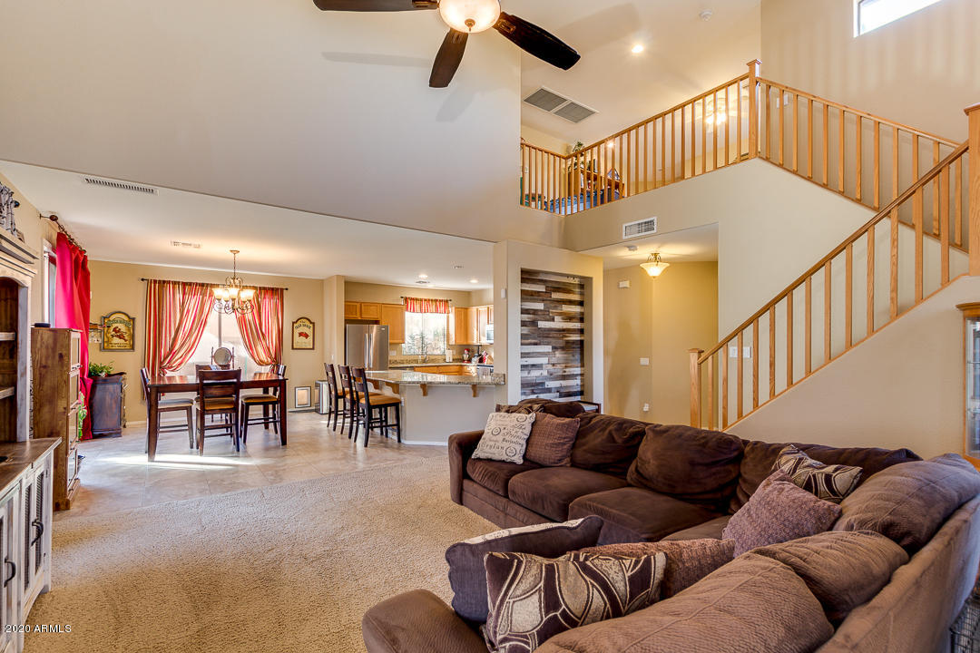 1163 East Ranch Court Gilbert, AZ 85296 - Photo 4 of 36 a living room with furniture ceiling fan and a rug