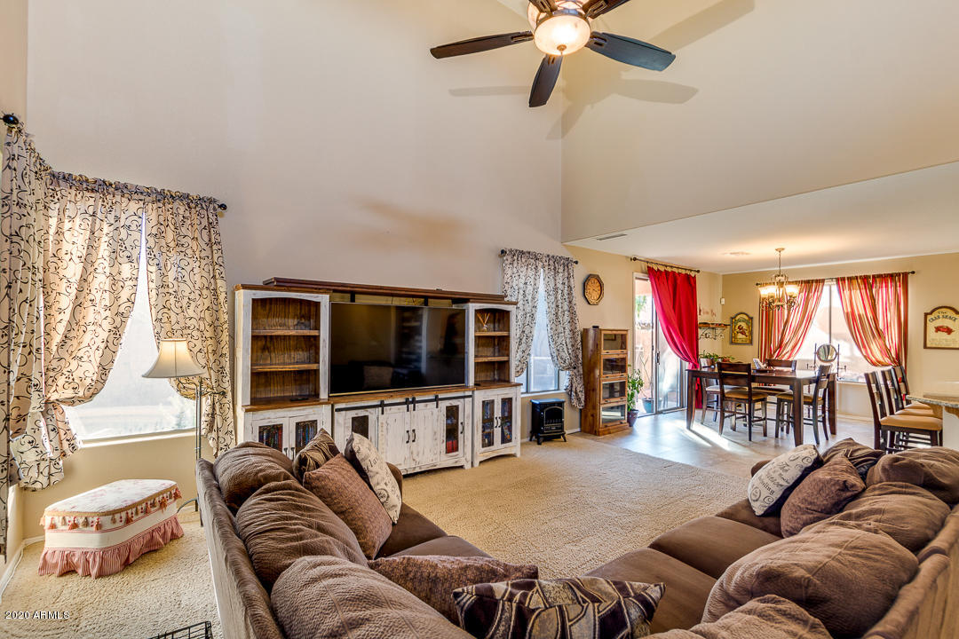 1163 East Ranch Court Gilbert, AZ 85296 - Photo 5 of 36 a living room with furniture and a flat screen tv