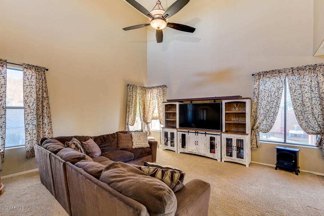 1163 East Ranch Court Gilbert, AZ 85296 - Photo 6 of 36 a living room with furniture and a flat screen tv