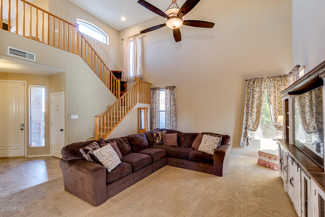 1163 East Ranch Court Gilbert, AZ 85296 - Photo 7 of 36 a living room with furniture and a flat screen tv