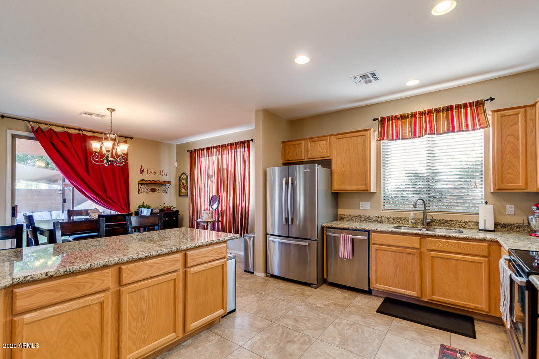 1163 East Ranch Court Gilbert, AZ 85296 - Photo 10 of 36 a kitchen with stainless steel appliances granite countertop a sink a stove and refrigerator
