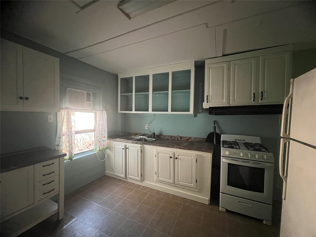 3529 Palm Road Shreveport, LA 71109 - Photo 5 of 18 Kitchen with white cabinets, sink, white refrigerator, and stainless steel gas range oven
