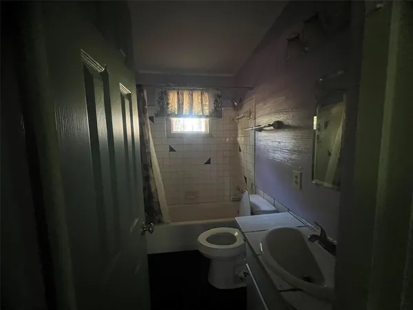 a bathroom with a granite countertop toilet a sink and shower