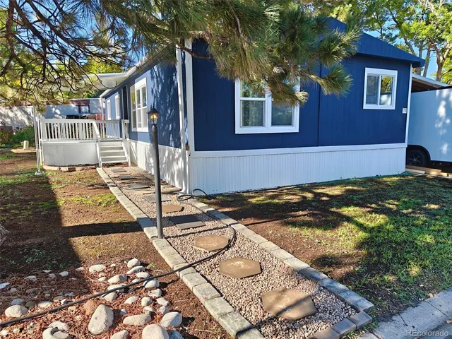 a view of a house with backyard porch and sitting area