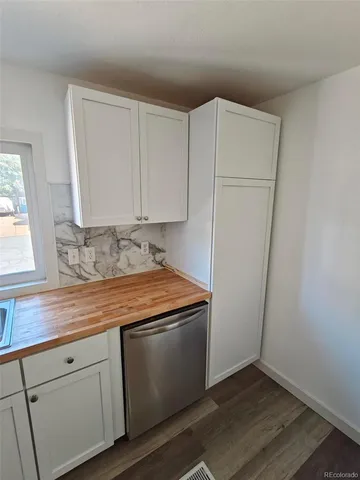 a view of a kitchen with sink and cabinets
