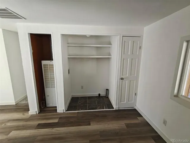 a view of a livingroom with wooden floor and a window