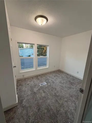 a view of an empty room with a fan