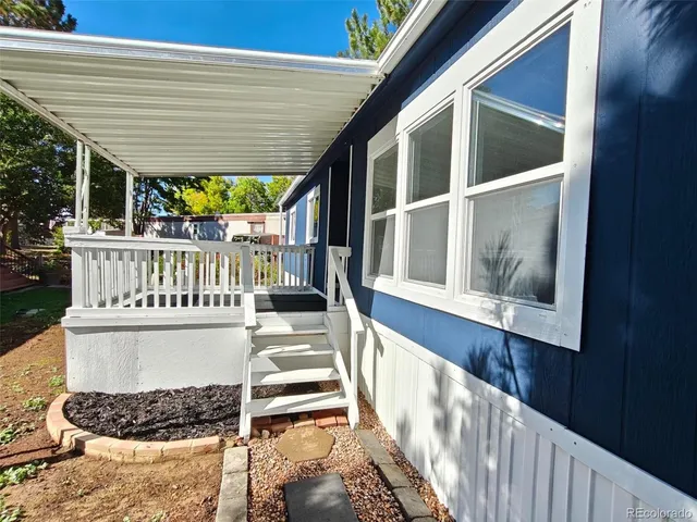 a view of a house with wooden deck and a porch