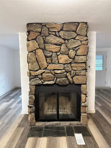 a view of fireplace with wooden floor