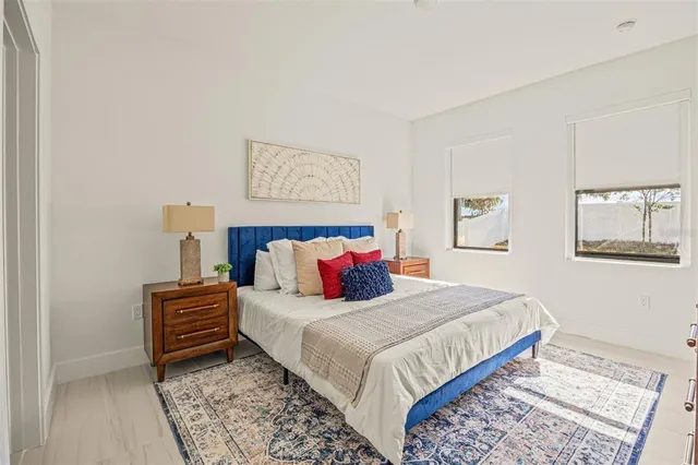 a bedroom with a bed and a lamp on table