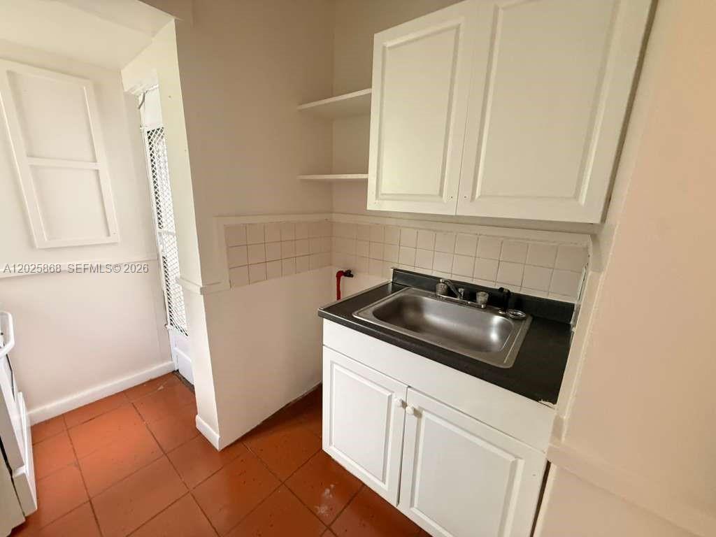 1919 Southwest 2nd Street, Unit B Miami, FL 33135 - Photo 7 of 12 a kitchen with a sink and a stove top oven