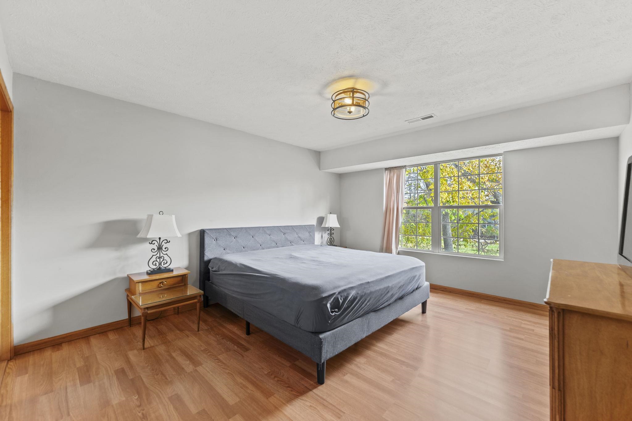 5694 Oak Village Drive Roscoe, IL 61073 - Photo 12 of 22 a bedroom with a bed and window