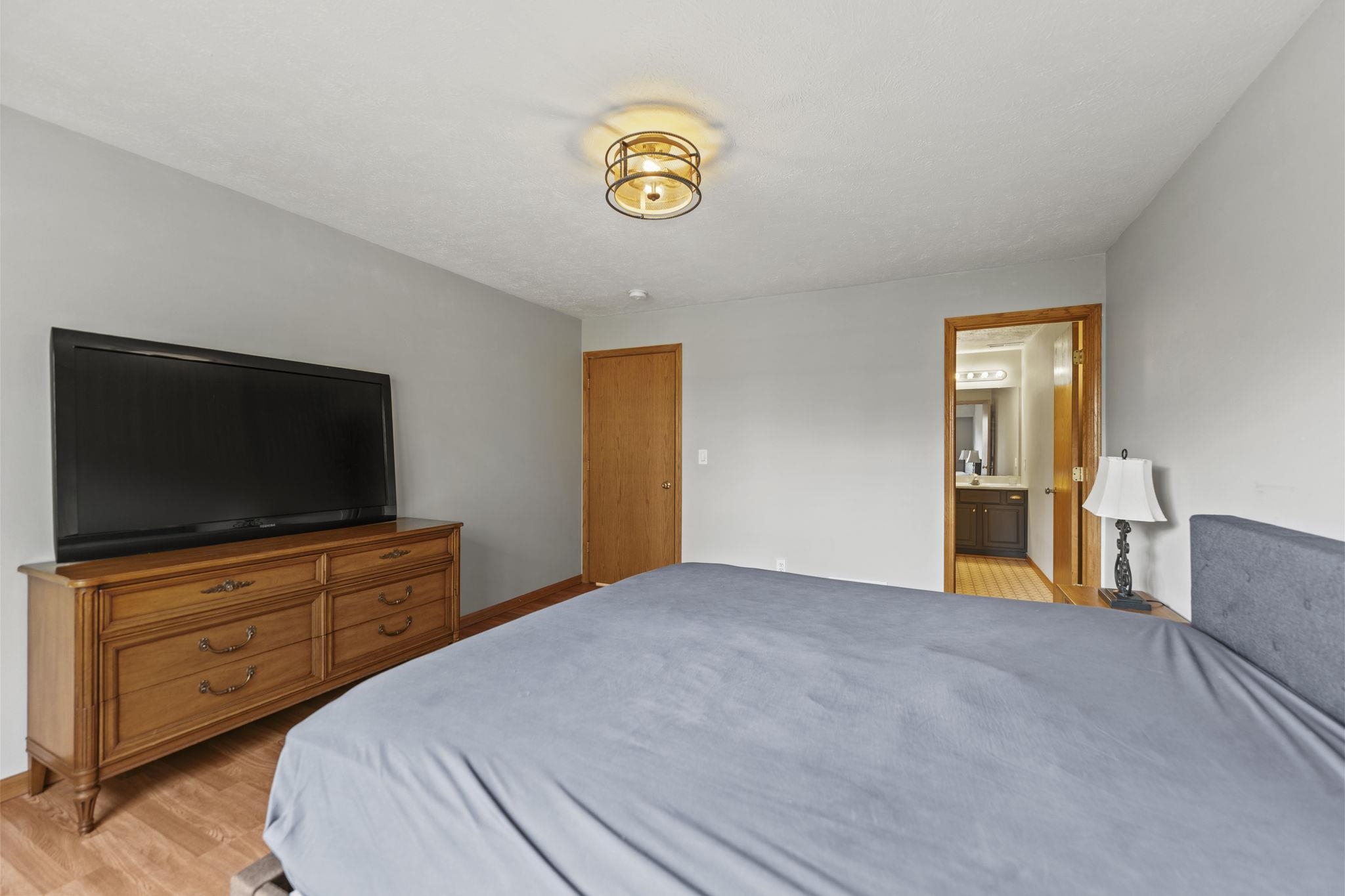 5694 Oak Village Drive Roscoe, IL 61073 - Photo 14 of 22 a bedroom with a bed and a flat screen tv