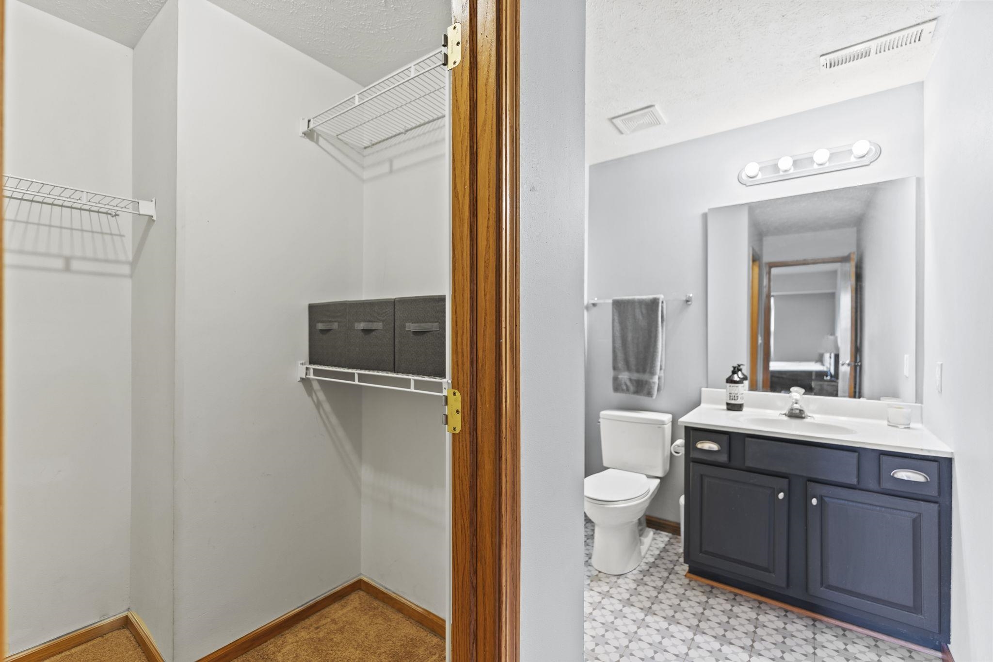 5694 Oak Village Drive Roscoe, IL 61073 - Photo 15 of 22 a en suite bathroom with a granite countertop sink toilet and shower